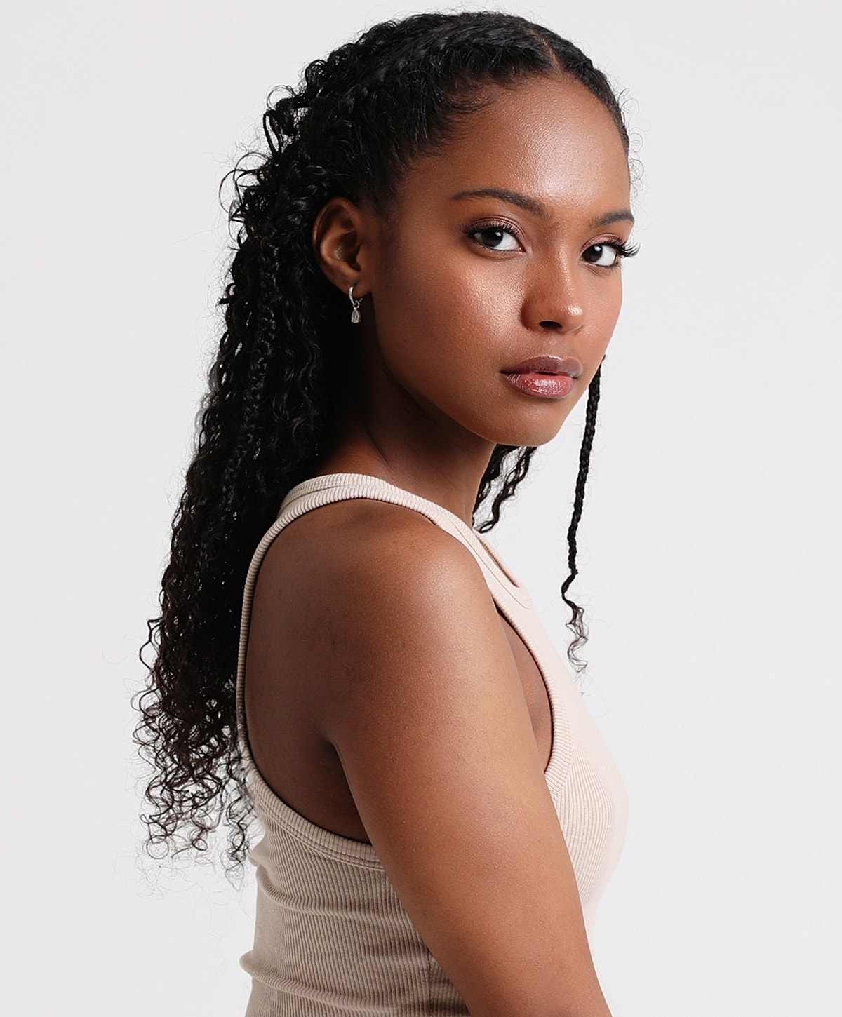 Woman with curly hair in a sleeveless top