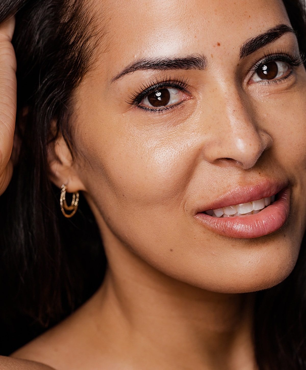 PDO Thread Lift model with glowing skin and earrings.