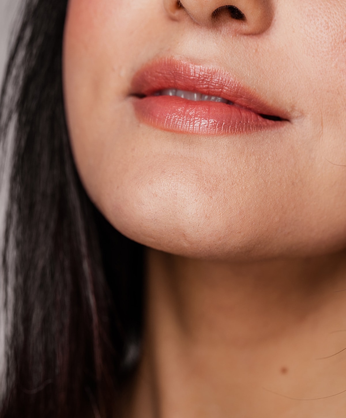 Close-up of lips and chin with soft lighting.