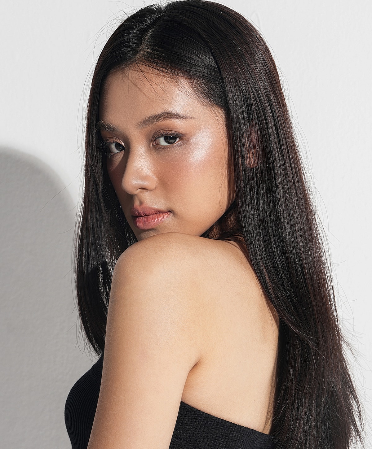 Restylane Lyft Model with long hair looking over her shoulder.