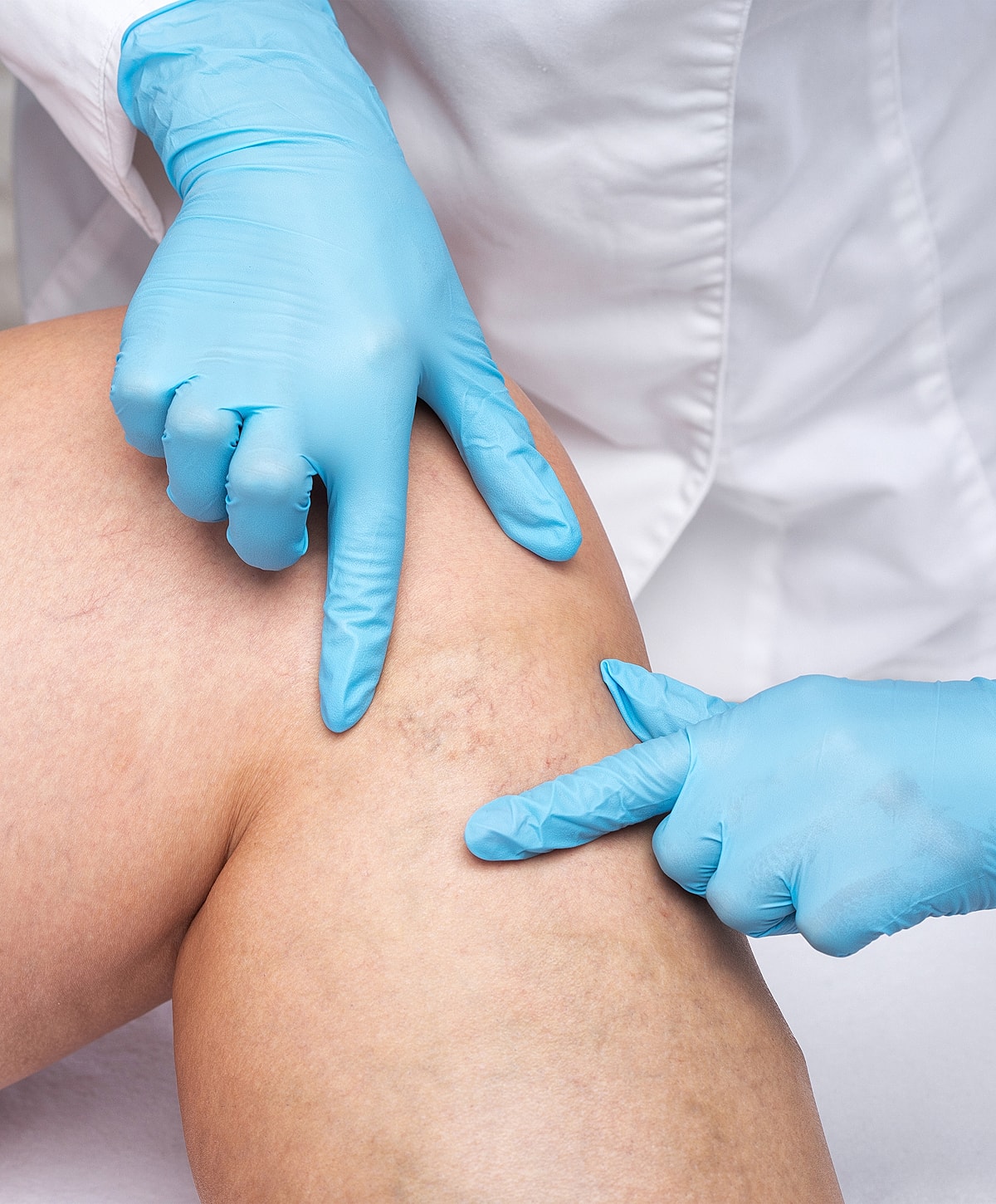 Rancho Santa Margarita Medical professional examining a patient's knee.