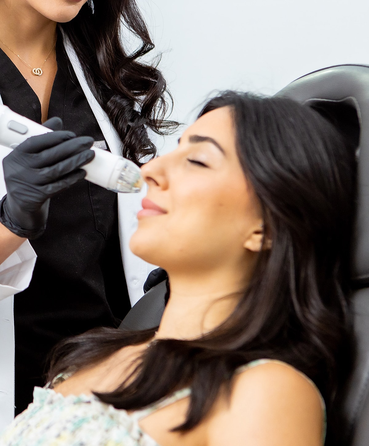 RF Microneedling model receiving facial treatment at a clinic.