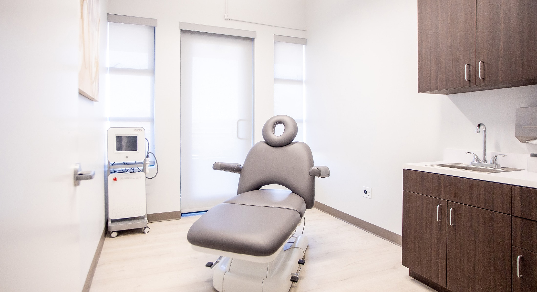 Modern medical examination room with treatment chair.