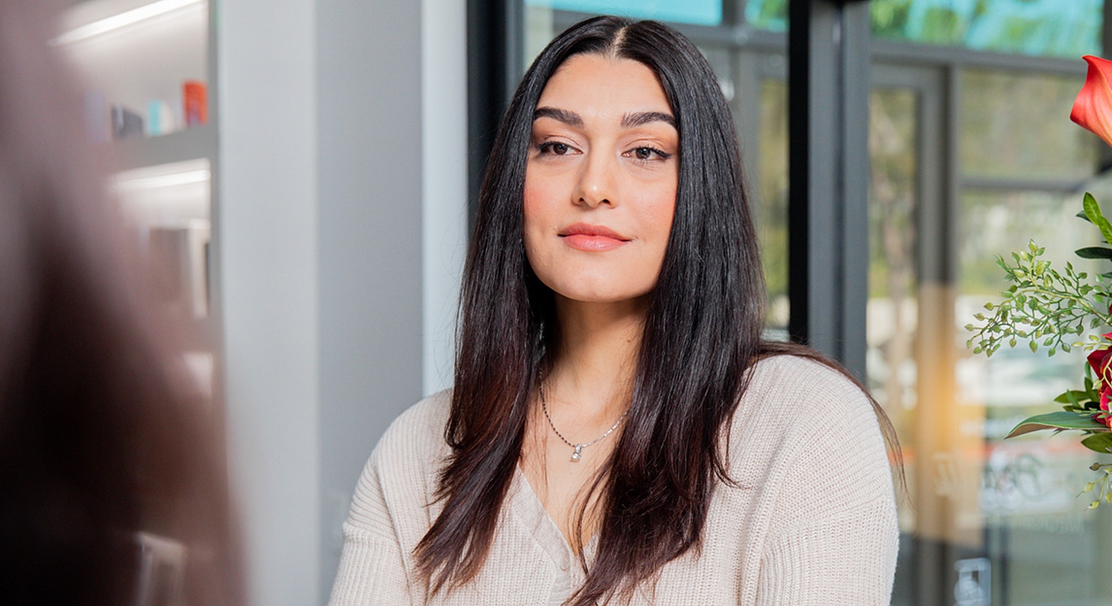 Rancho Santa Margarita Acne Scar Treatment model with long hair in bright interior setting.