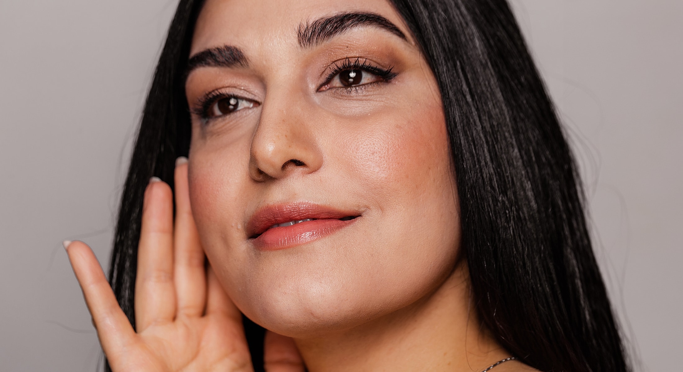 Newport Beach Laser Skin Resurfacing model with long hair listening attentively.