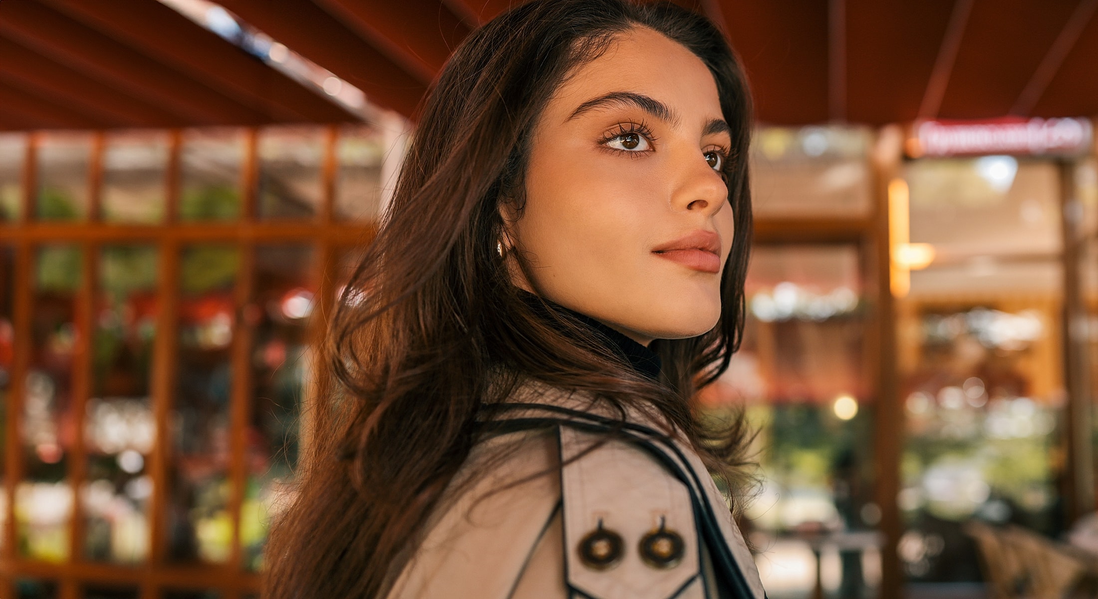 Newport Beach & Rancho Santa Margarita PRP Hair Restoration model with long hair looking thoughtfully outdoors.